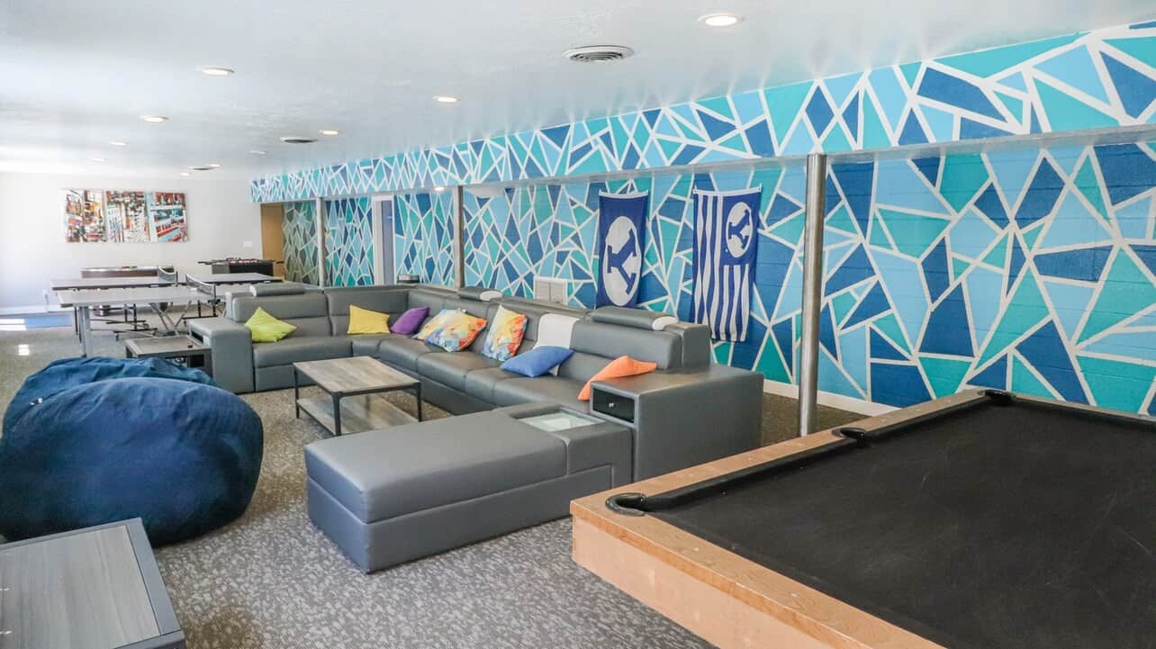 room with beanbag chairs, couches, and pool tables