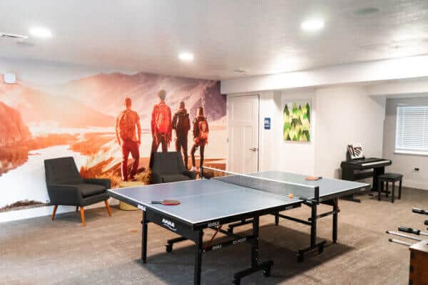 room with ping-pong table and chairs