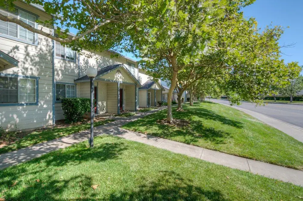 front doors of apartments with lawns